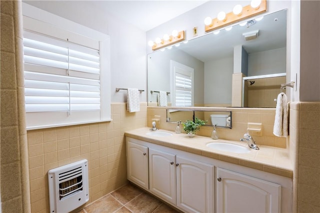 253 Melrose, Corpus Christi, TX 78404 - bathroom featuring heating unit, tile walls, tile patterned flooring, double vanity, and a shower