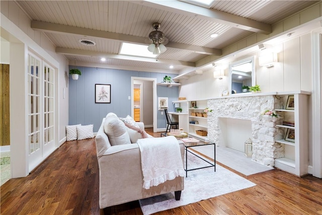 253 Melrose, Corpus Christi, TX 78404 - living room featuring ceiling fan, wood finished floors, beam ceiling, a fireplace with flush hearth, and baseboards