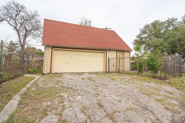 detached garage featuring fence
