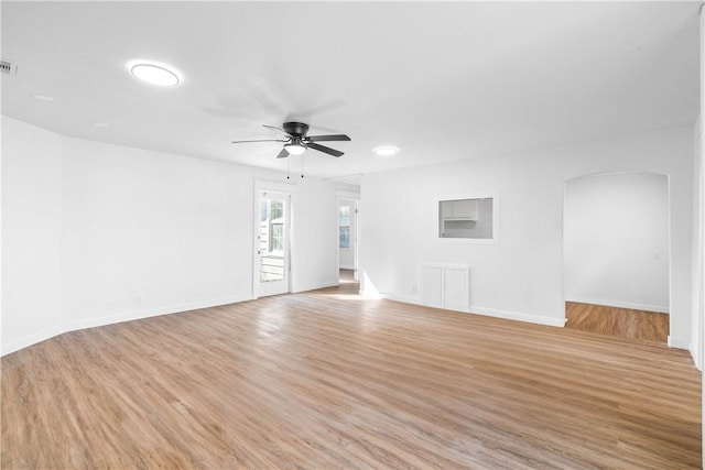 1601 Cambridge Dr, Corpus Christi, TX 78415 - unfurnished room with arched walkways, a ceiling fan, and light wood finished floors