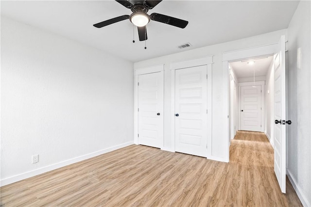 1601 Cambridge Dr, Corpus Christi, TX 78415 - unfurnished bedroom featuring attic access, light wood finished floors, a ceiling fan, and a closet