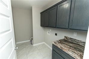 laundry area featuring electric dryer hookup, hookup for a washing machine, and cabinets