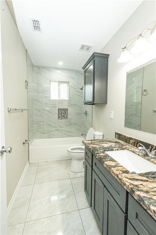 full bathroom featuring tiled shower / bath combo, toilet, and vanity