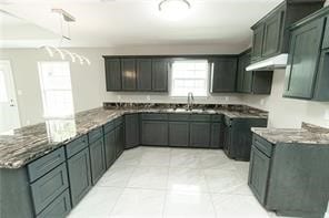 kitchen featuring light tile patterned flooring and dark stone countertops