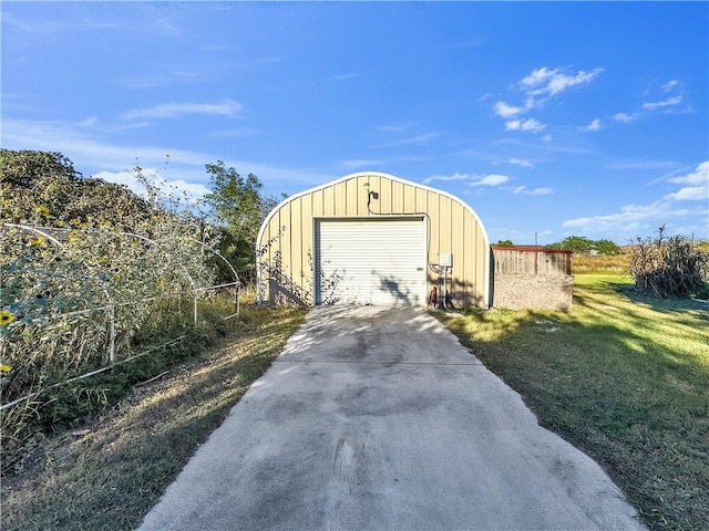 view of outdoor structure featuring a yard and a garage