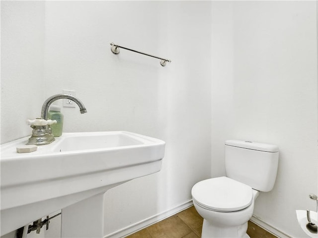 bathroom with sink, tile patterned floors, and toilet