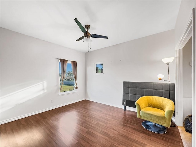 sitting room featuring hardwood / wood-style floors and ceiling fan