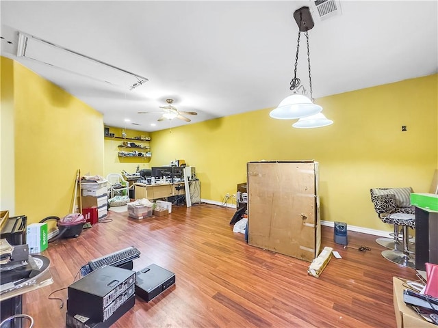 workout room with ceiling fan and wood-type flooring