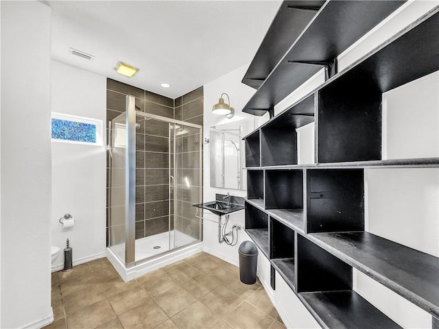 bathroom with tile patterned flooring and a shower with shower door