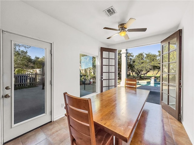 dining space with light tile patterned floors, french doors, and ceiling fan