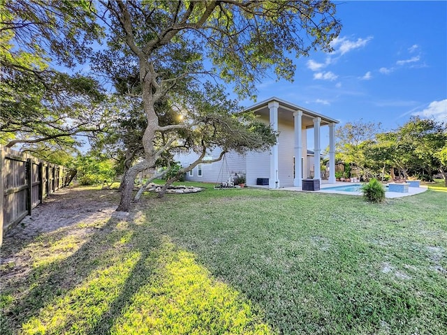 view of yard with a fenced in pool, cooling unit, and a patio area