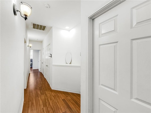 corridor with dark hardwood / wood-style floors