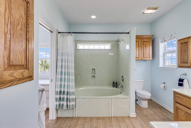 full bathroom featuring plenty of natural light, vanity, hardwood / wood-style flooring, and shower / tub combo with curtain