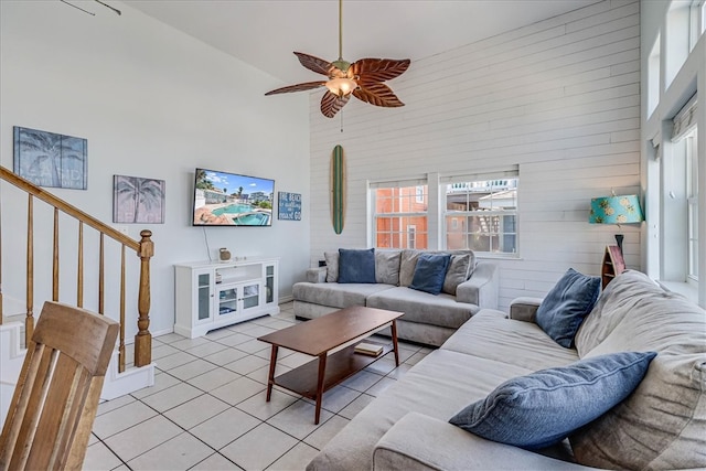 living room with high vaulted ceiling, light tile patterned floors, and ceiling fan