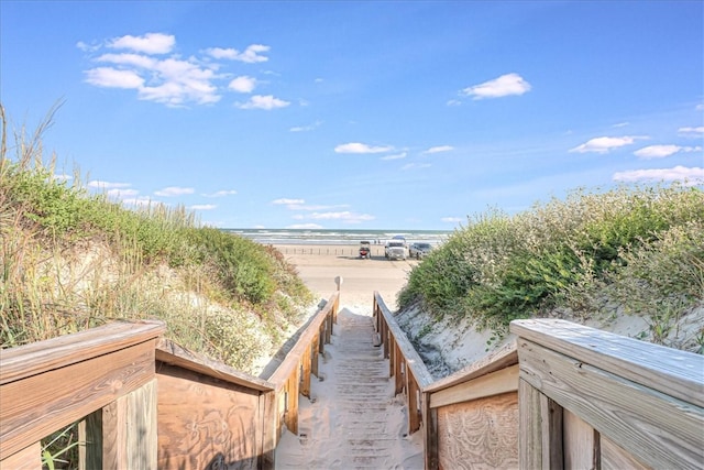 surrounding community featuring a view of the beach and a water view