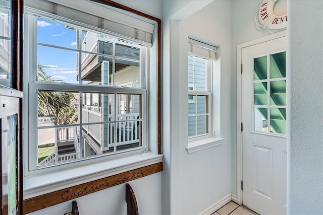 entryway featuring a wealth of natural light and light tile patterned floors