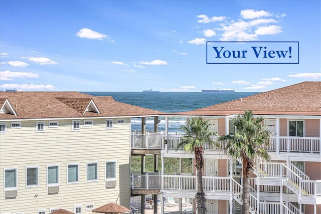 exterior space featuring a balcony and a water view