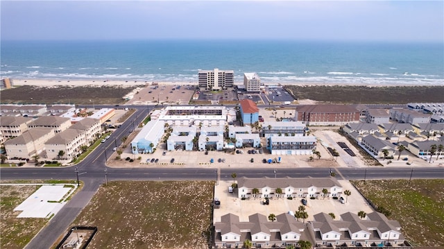 aerial view with a water view and a beach view