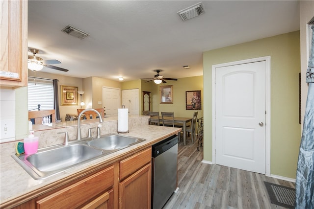 kitchen with stainless steel dishwasher, ceiling fan, sink, and light hardwood / wood-style flooring