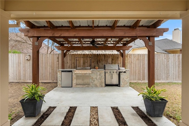 view of patio / terrace featuring grilling area, a pergola, and exterior kitchen