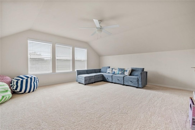 carpeted living room featuring ceiling fan and vaulted ceiling