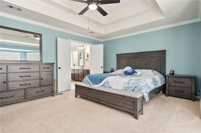 carpeted bedroom with ceiling fan, ornamental molding, connected bathroom, and a raised ceiling