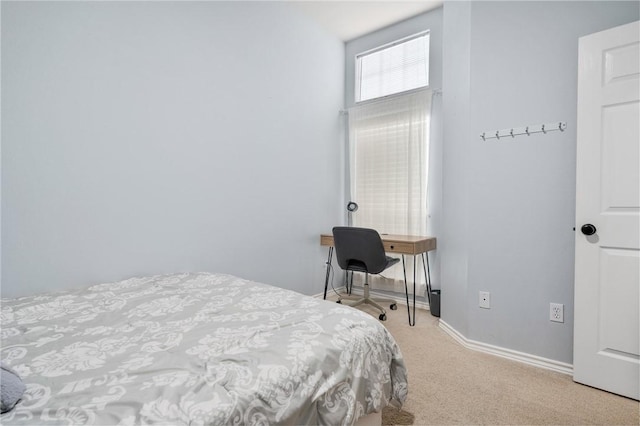 bedroom featuring light colored carpet