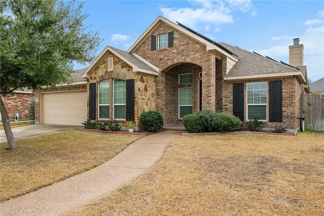 view of property with a garage and a front yard