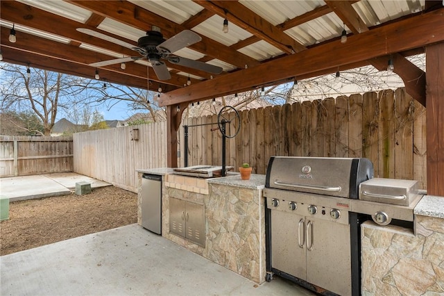 view of patio / terrace with grilling area, ceiling fan, and exterior kitchen