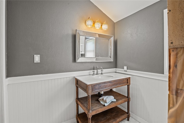 bathroom featuring vanity and vaulted ceiling