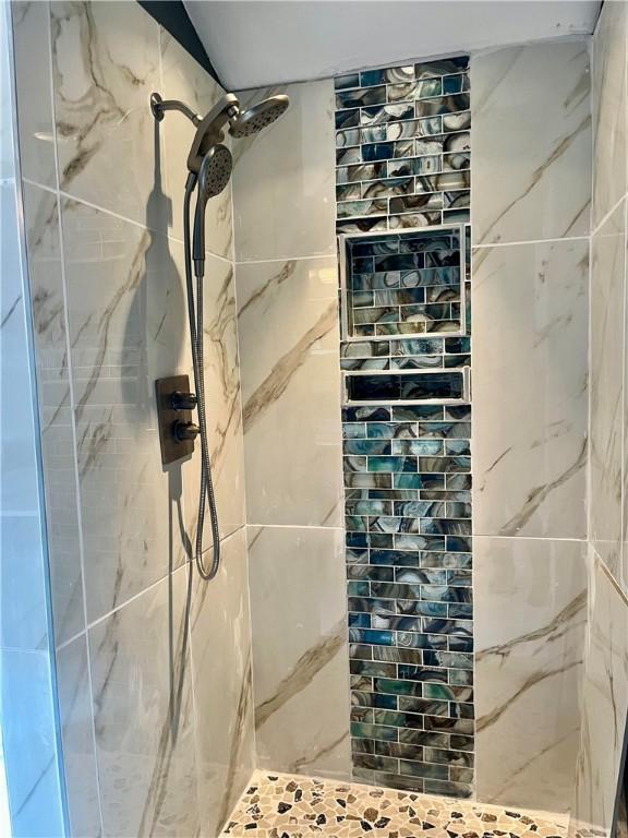 interior space with tiled shower