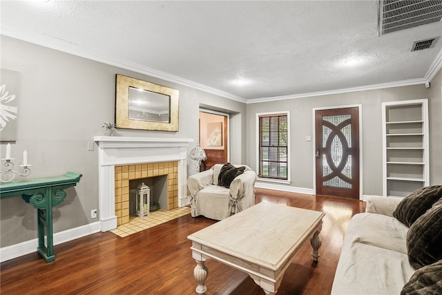 living room with a fireplace, a textured ceiling, dark hardwood / wood-style flooring, and ornamental molding