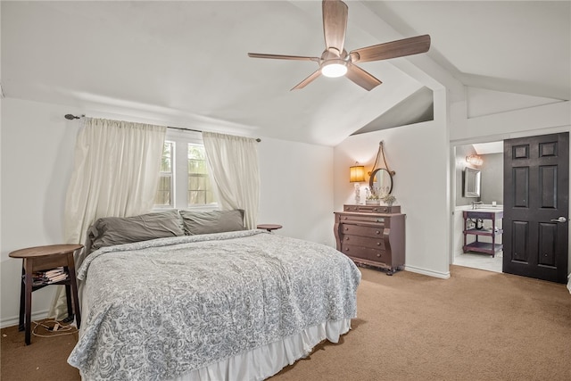 carpeted bedroom with ceiling fan, connected bathroom, and lofted ceiling