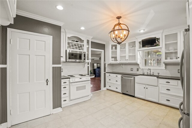 kitchen with white cabinetry, decorative light fixtures, ornamental molding, and stainless steel appliances