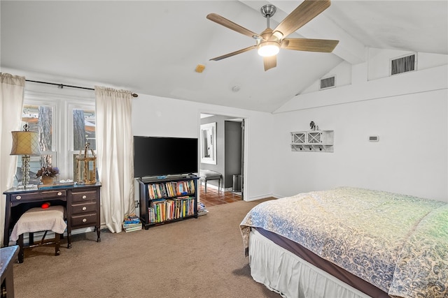 bedroom with ceiling fan, vaulted ceiling, and carpet floors