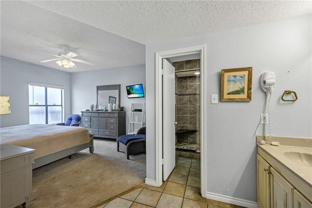 bedroom with ceiling fan, sink, light carpet, and a textured ceiling