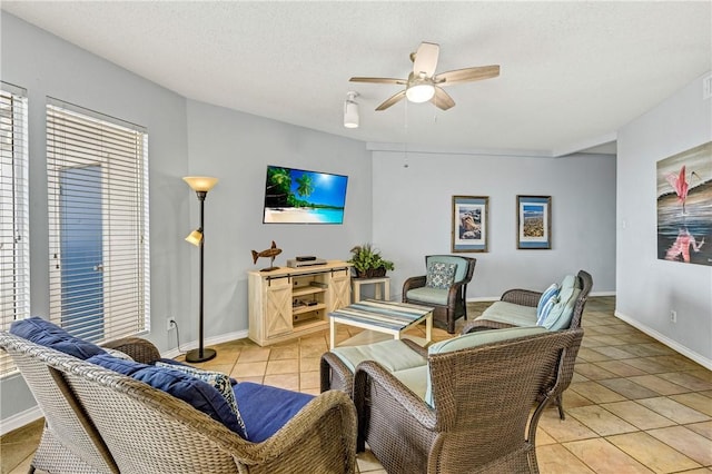 living room with light tile patterned floors, a textured ceiling, and ceiling fan