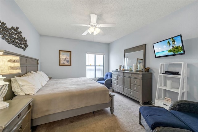 bedroom with light carpet, ceiling fan, and a textured ceiling