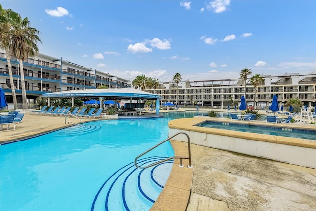 view of pool featuring a hot tub and a patio