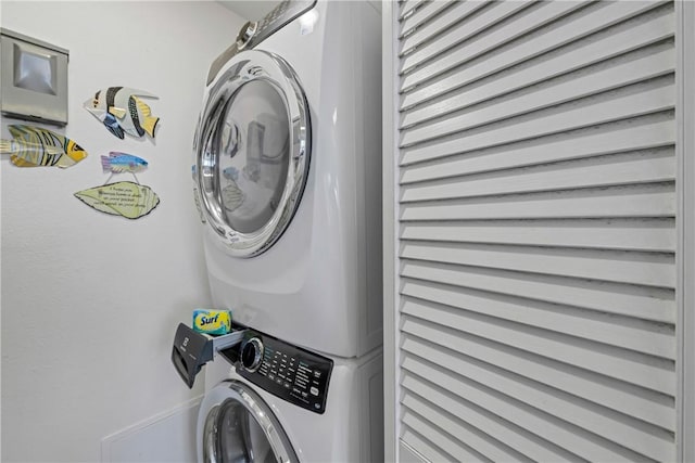 laundry room with stacked washer and dryer