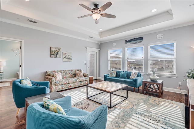 living room featuring crown molding, wood-type flooring, ceiling fan, and a raised ceiling