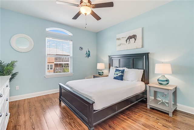 bedroom with ceiling fan and dark hardwood / wood-style flooring