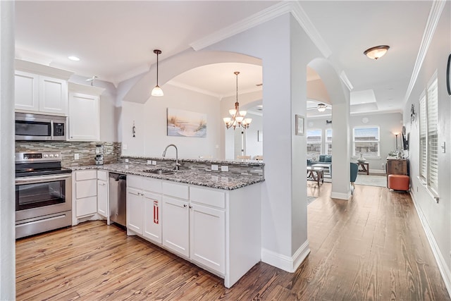 kitchen featuring light hardwood / wood-style floors, sink, light stone countertops, white cabinetry, and appliances with stainless steel finishes