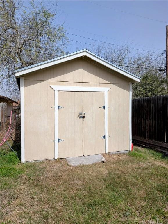 view of shed featuring fence