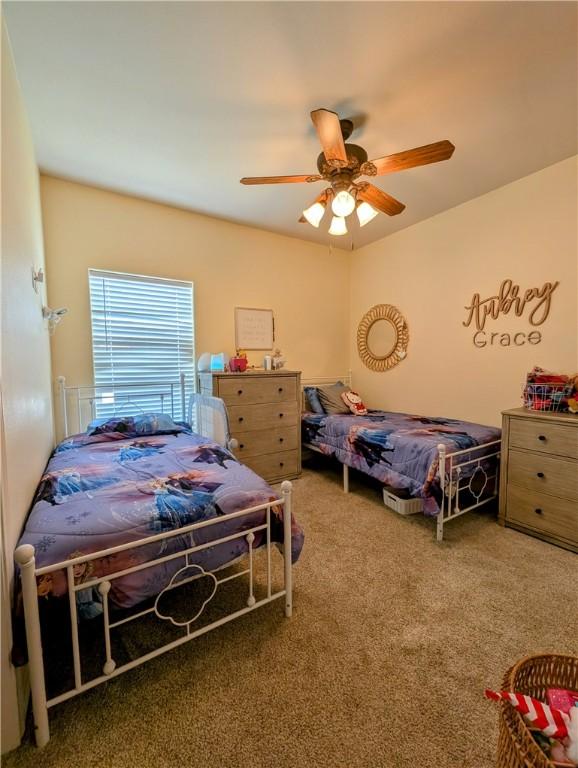 carpeted bedroom with a ceiling fan