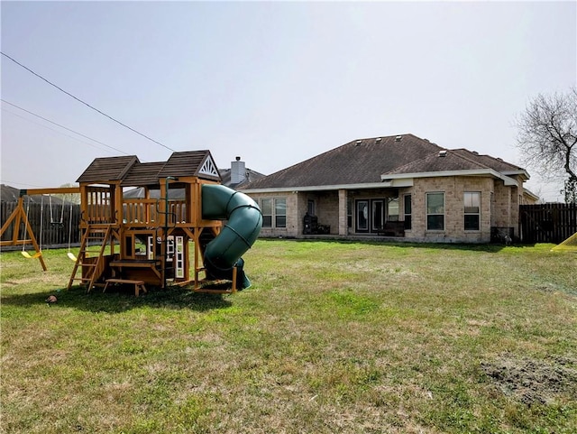 exterior space featuring fence, a lawn, and a playground