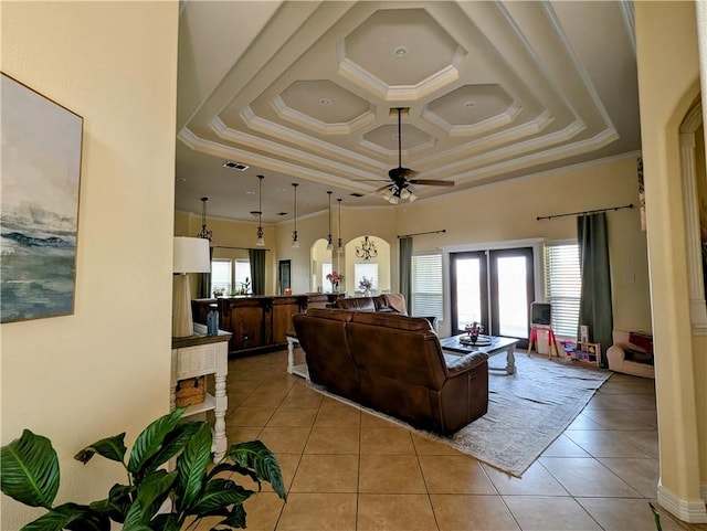 living area with coffered ceiling, crown molding, visible vents, and light tile patterned floors