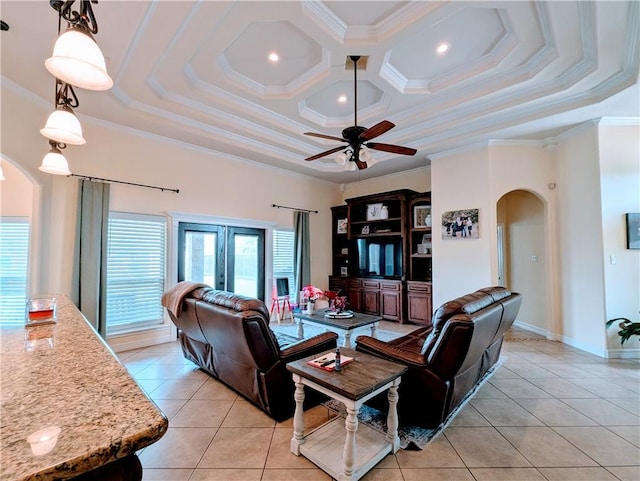 living room with arched walkways, ceiling fan, light tile patterned floors, and ornamental molding