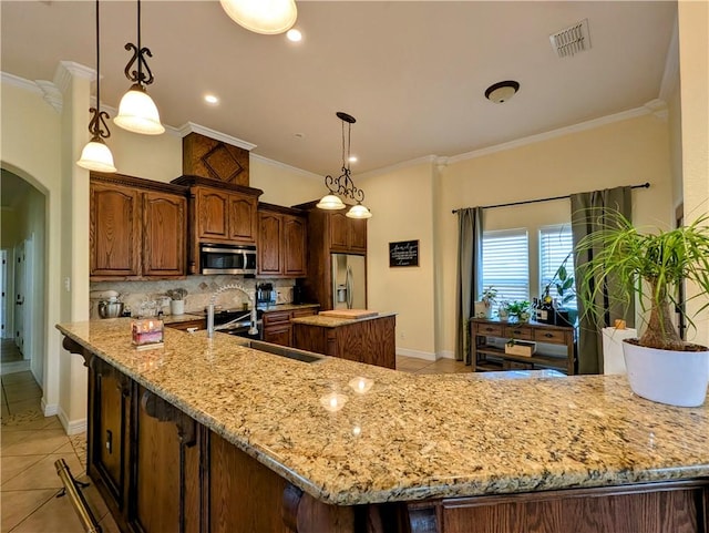 kitchen featuring arched walkways, light tile patterned floors, tasteful backsplash, visible vents, and appliances with stainless steel finishes