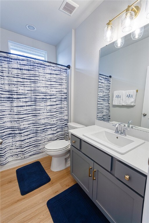 2634 Westeros St, Corpus Christi, TX 78415 - bathroom with vanity, wood finished floors, and a shower with curtain